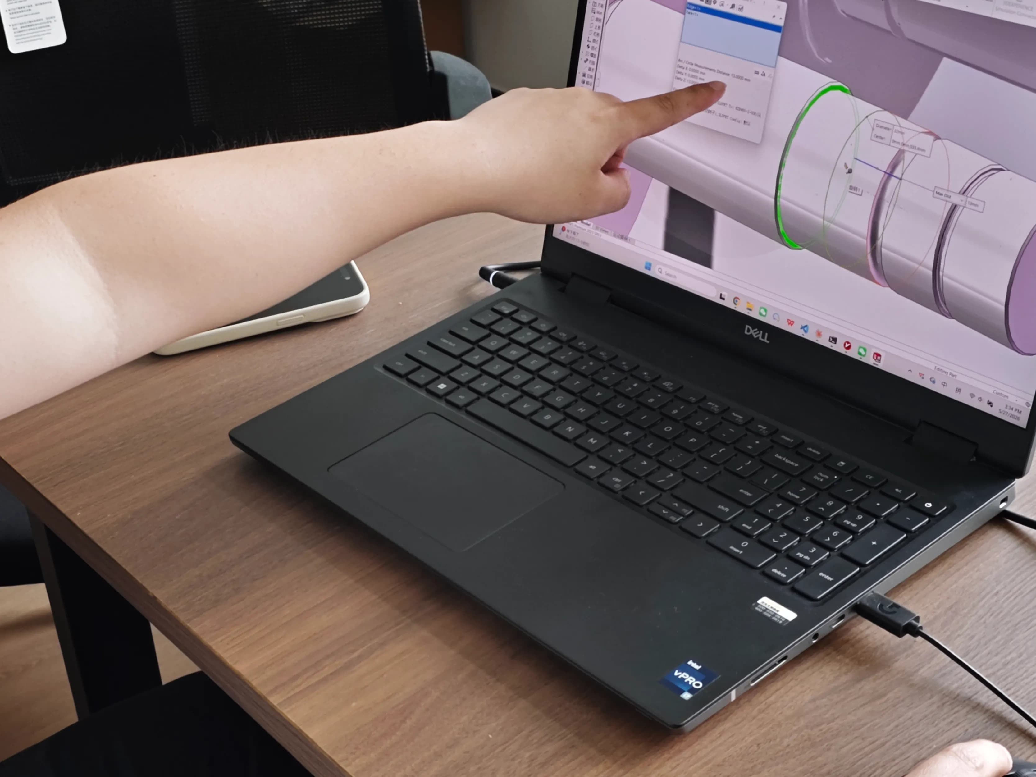 SCPM engineer reviewing a customer's CAD blueprint to verify critical dimensions