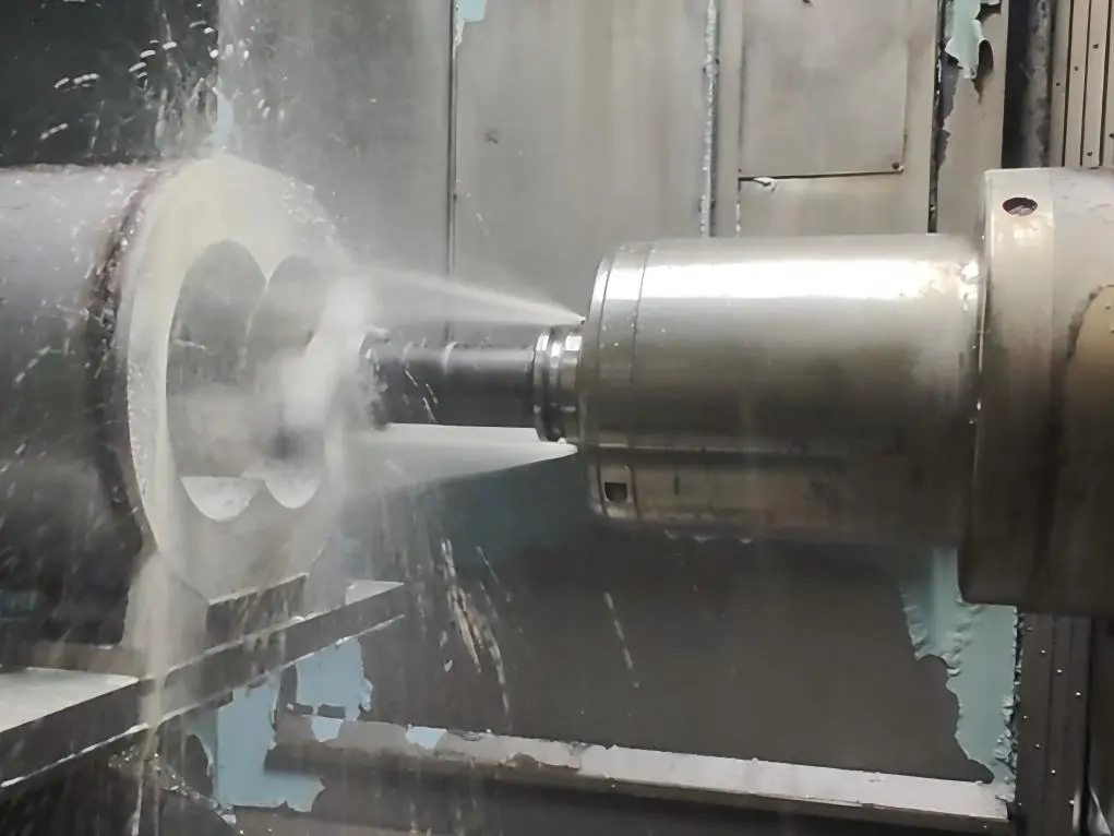 Dry screw vacuum pump housing fixtured on its feet on a 4-axis horizontal machining center, mid-process for twin-bore finish boring in a single setup