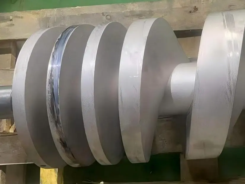 Discharge-end scrape band on a dry screw vacuum pump rotor — corrosion-resistant coating worn through where the rotor brushed the bore during the live test